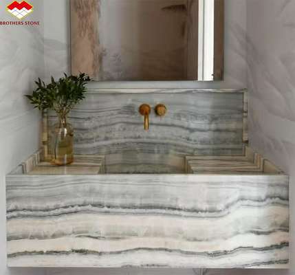 Panel de pared del baño del hotel y lavabo de vanidad con fregadero hecho de piedra natural mármol ónix