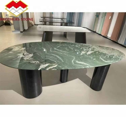 Mesa de comedor de hotel moderno con superficie de mármol verde pulido y diseño gráfico personalizado