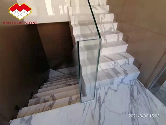 Barandillas de escaleras interiores de la villa hechas de piedra de mármol natural y escalones dorados de Calacatta